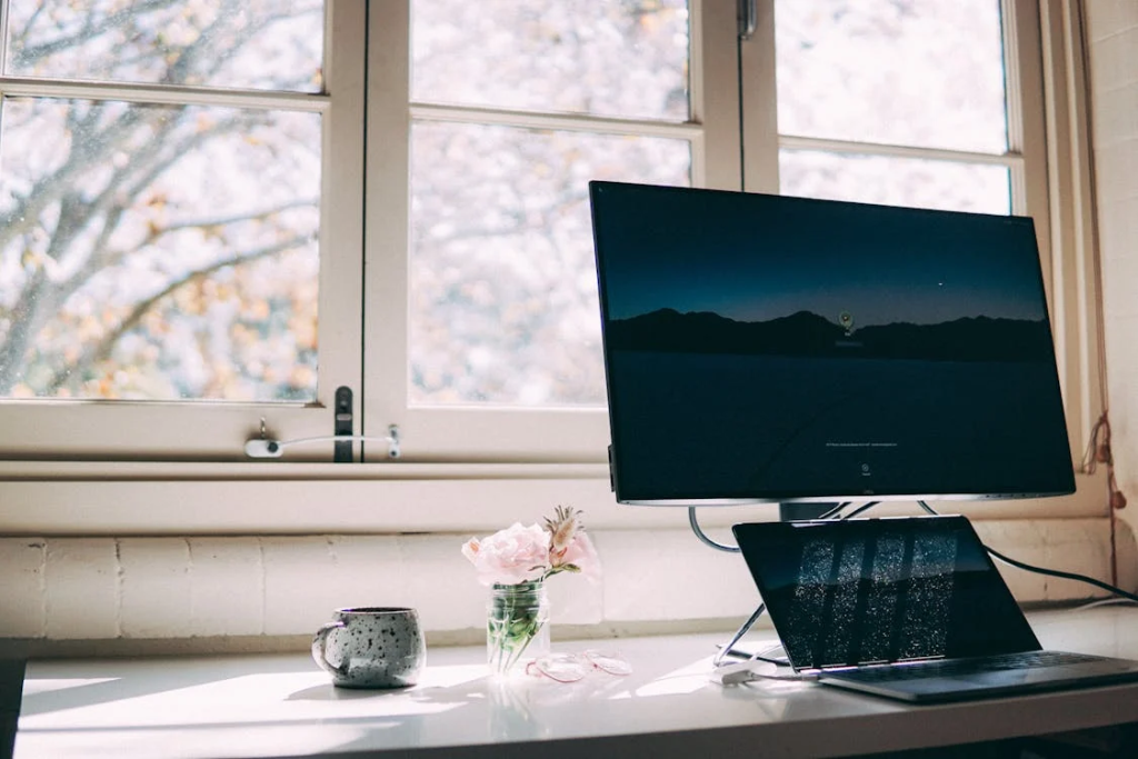 A Laptop and a Monitor on a Desk
