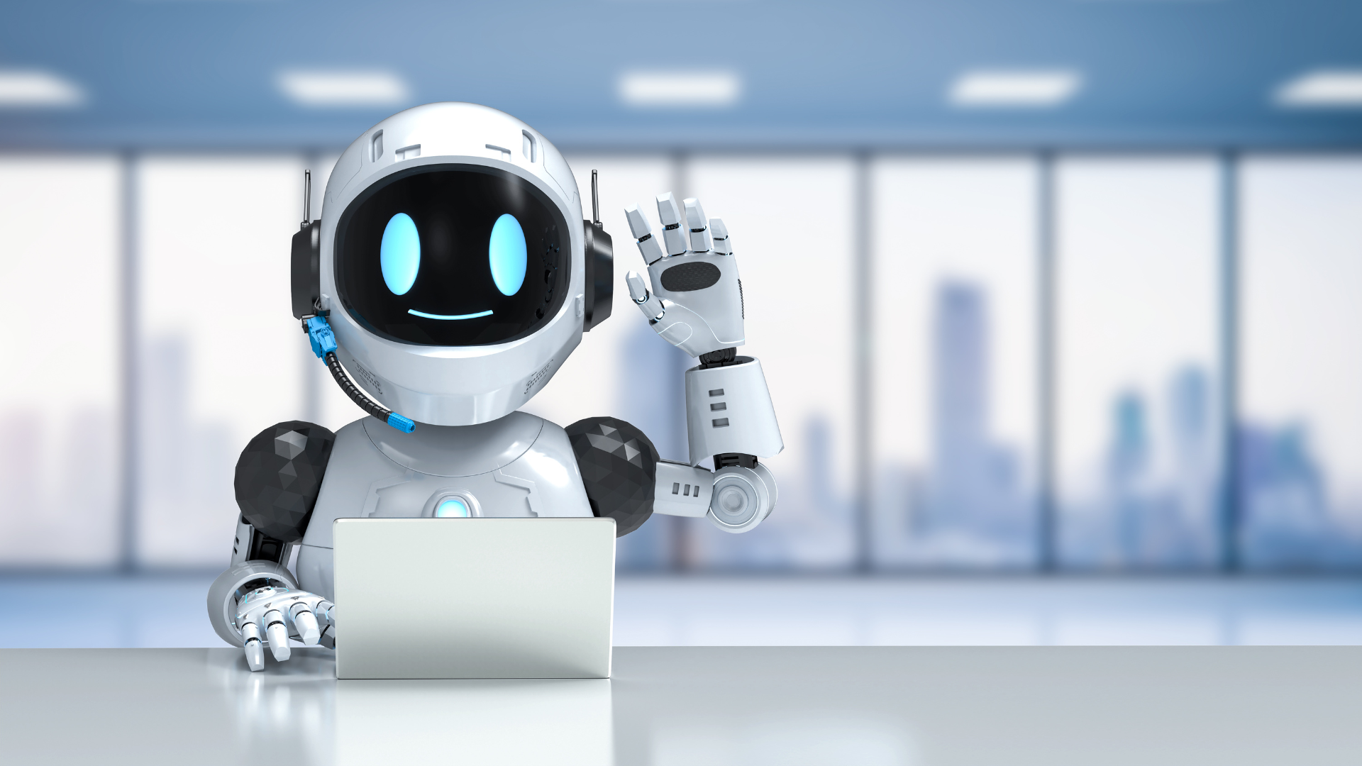 A humanoid robot with a smiling face sits at a desk with a laptop, raising its right hand in a modern office setting with large windows and city views.