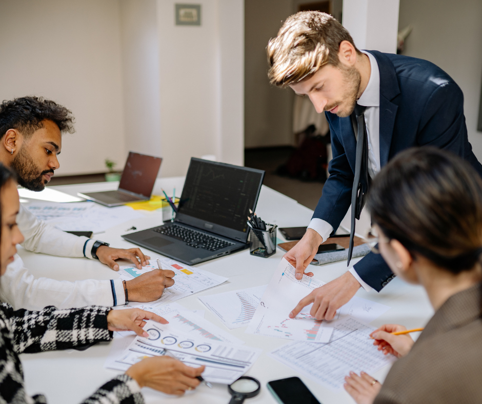 Business team reviewing reports and preparing for employment law changes through clear planning and communication