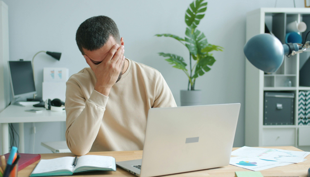 stressed employee sat at the desk