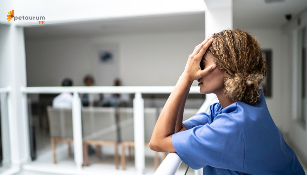 Employee experiencing distress at work, representing the challenges of reporting harassment in the workplace.